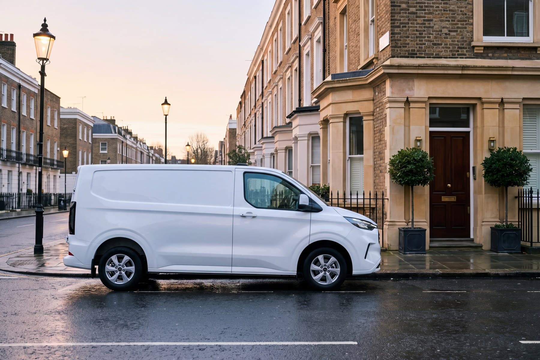 A white van parked on a London street at first light